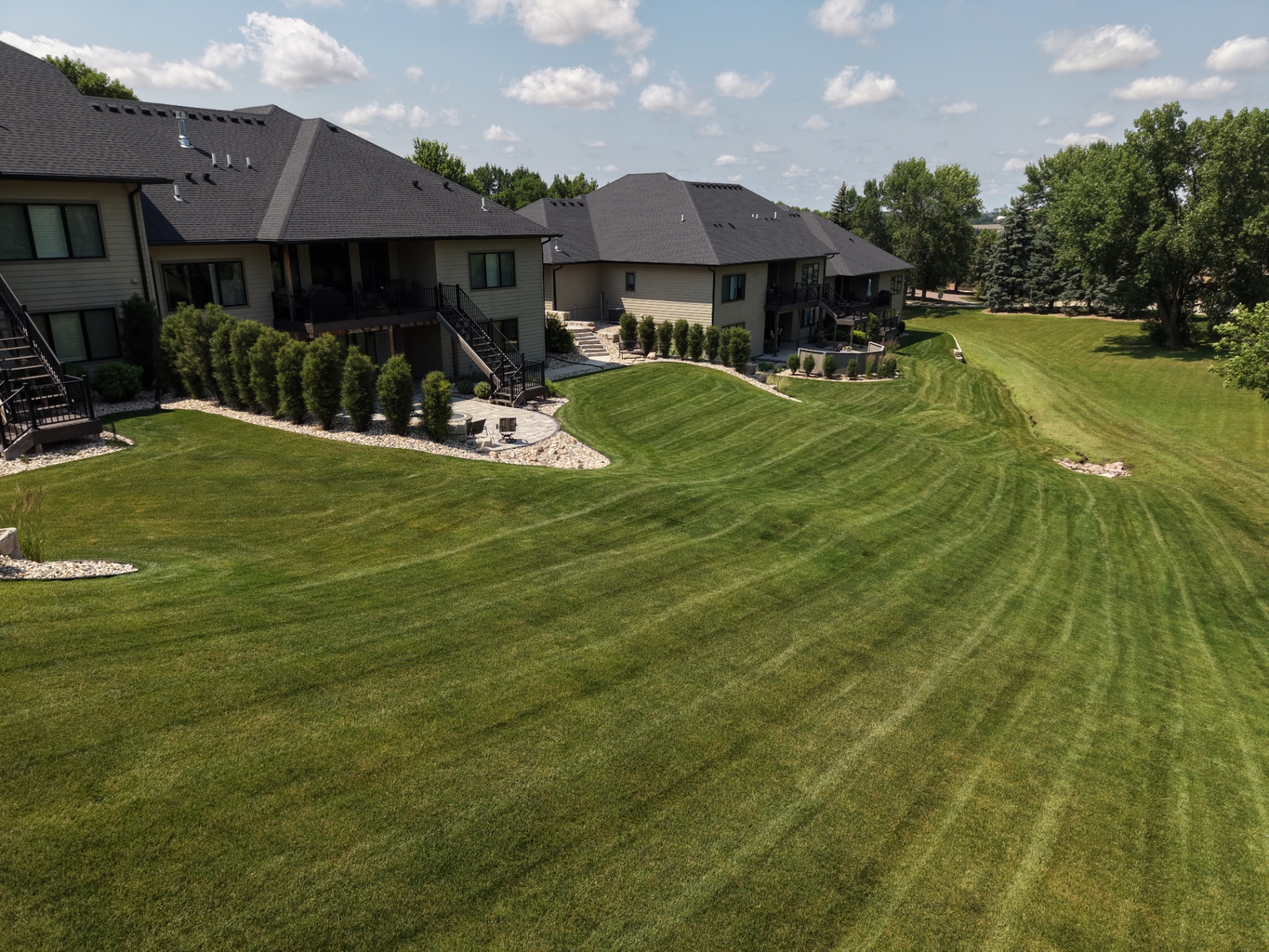 Aerial drone shot of a sweeping Kerwin-mowed lawn with curved stripes in Sioux Falls